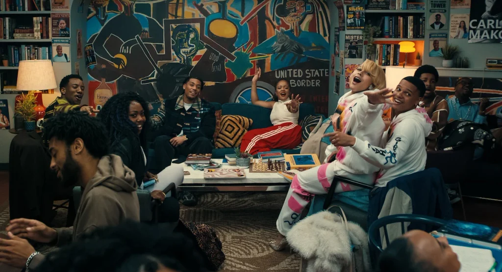 A Different World's younger cast gathers around a coffee table with a chessboard, books, and snacks