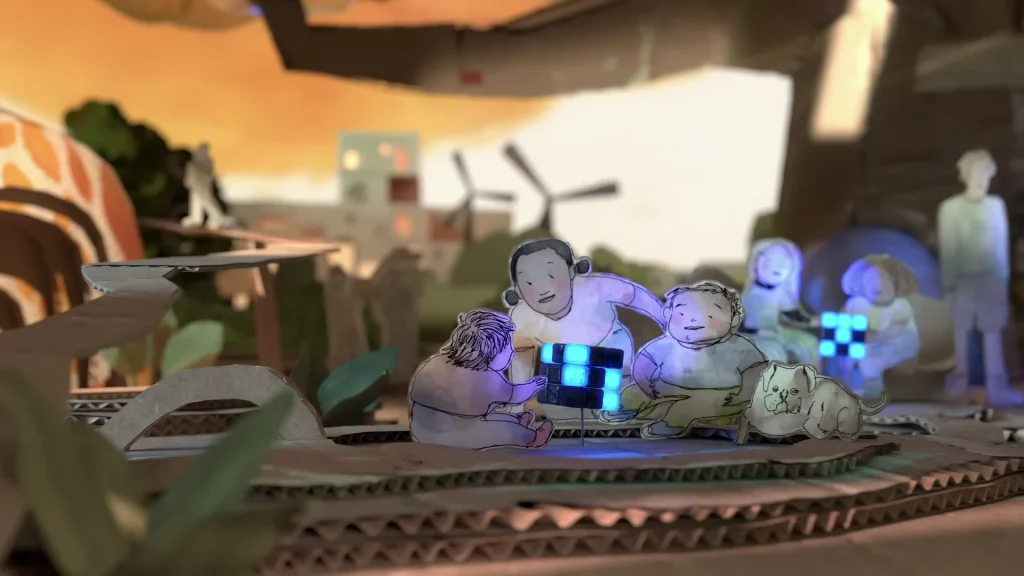 Paper figures gather around glowing blue blocks on a layered cardboard set in The AI Doc trailer
