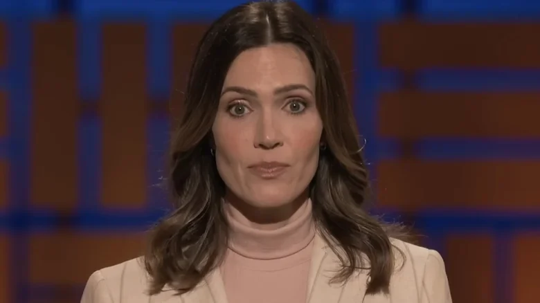 Mandy Moore as Katie Wilcox faces the camera against the Shark Tank stage backdrop in The Breadwinner