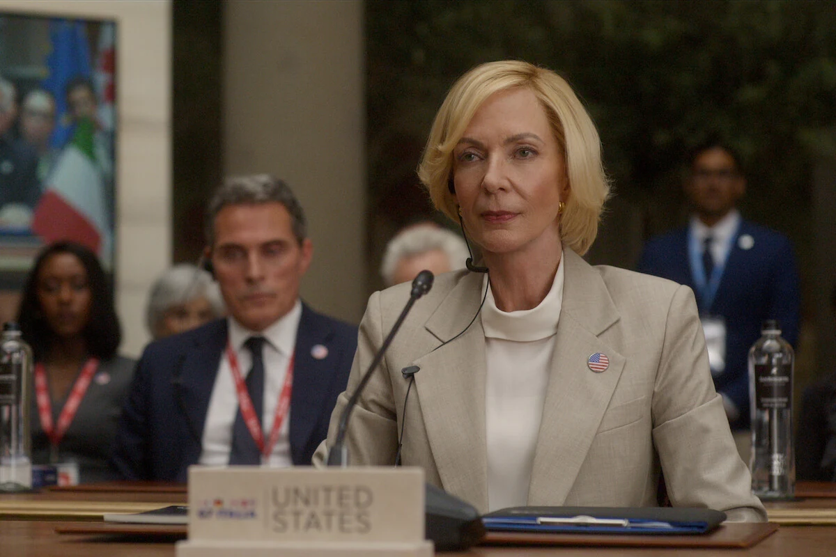 Grace Penn sits at the United States desk with Hal Wyler behind her at the G7 summit