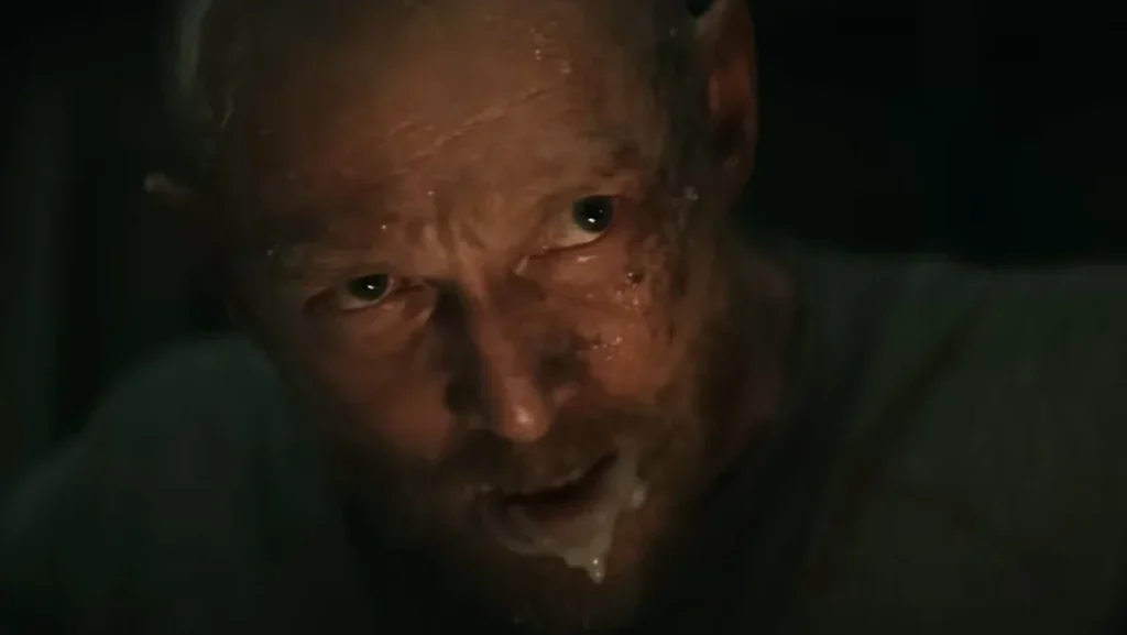 Edgar with foam around his mouth during the family dinner in Evil Dead Burn.
