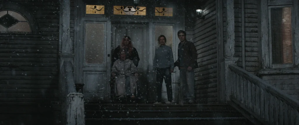 Four people, including one in a wheelchair, outside the family home in Evil Dead Burn.