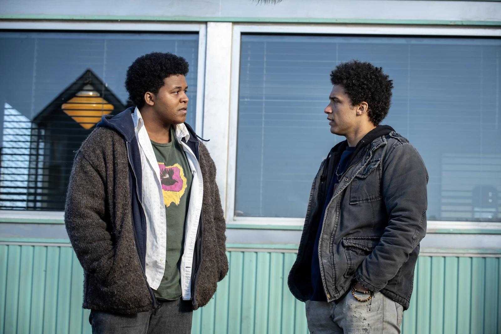 Elgin and Ellis face each other outside a building in FROM Season 3.