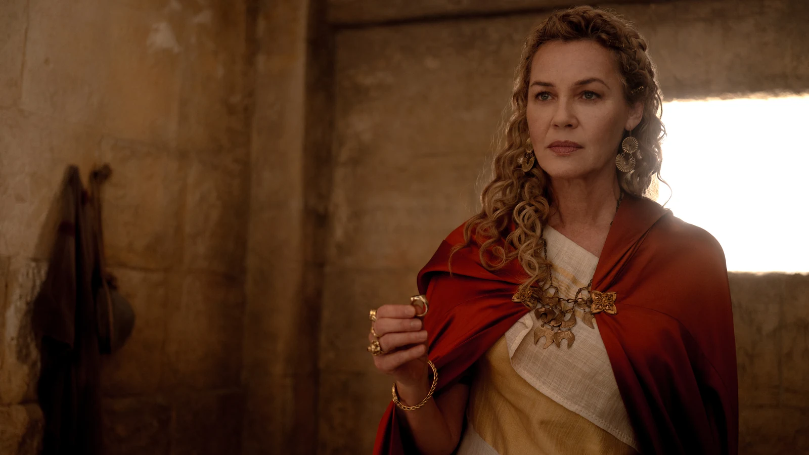 Lucilla wears a red cloak over a white dress in Gladiator II.