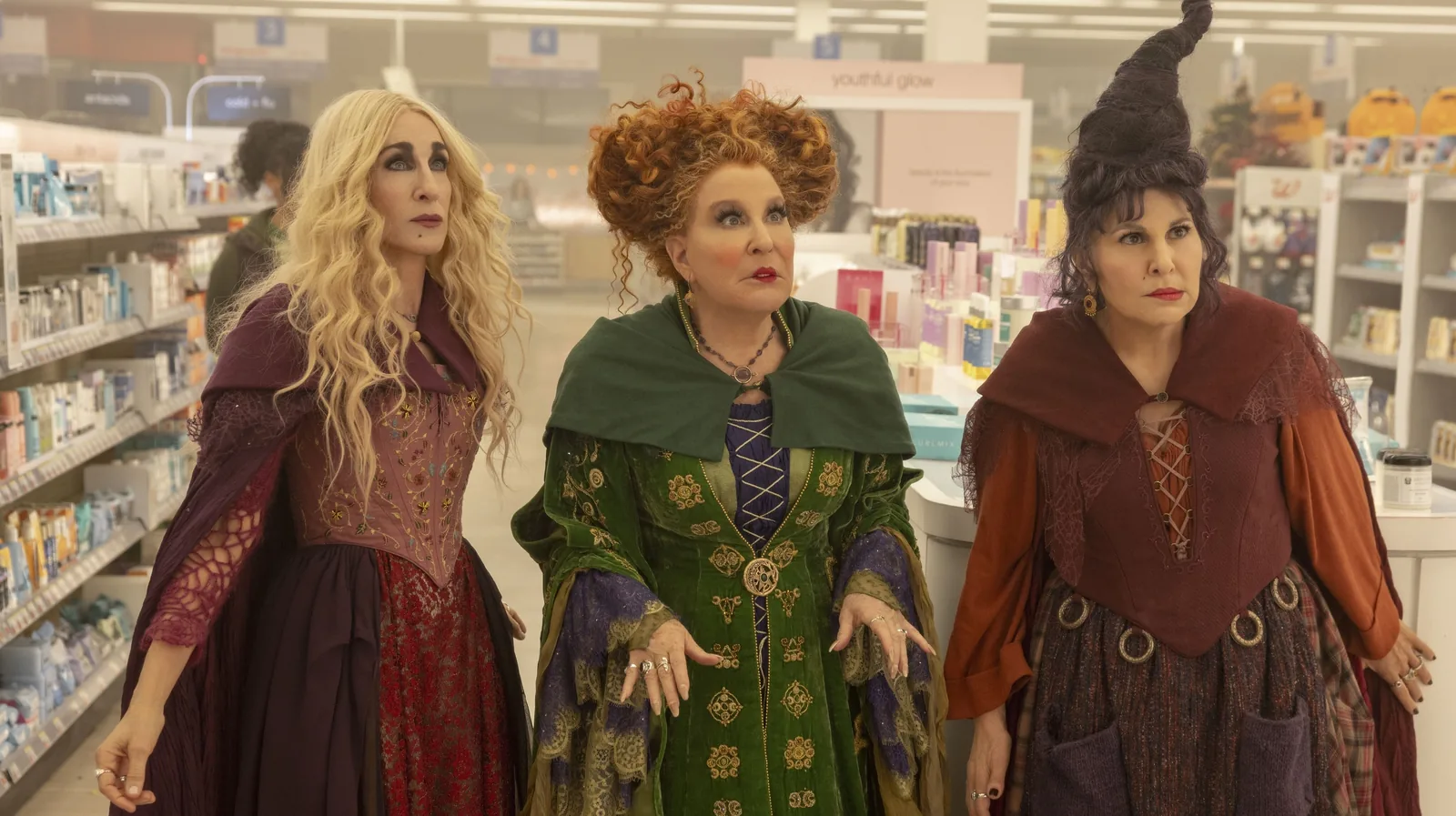 Sarah, Winifred, and Mary stand together among store shelves in Hocus Pocus 2