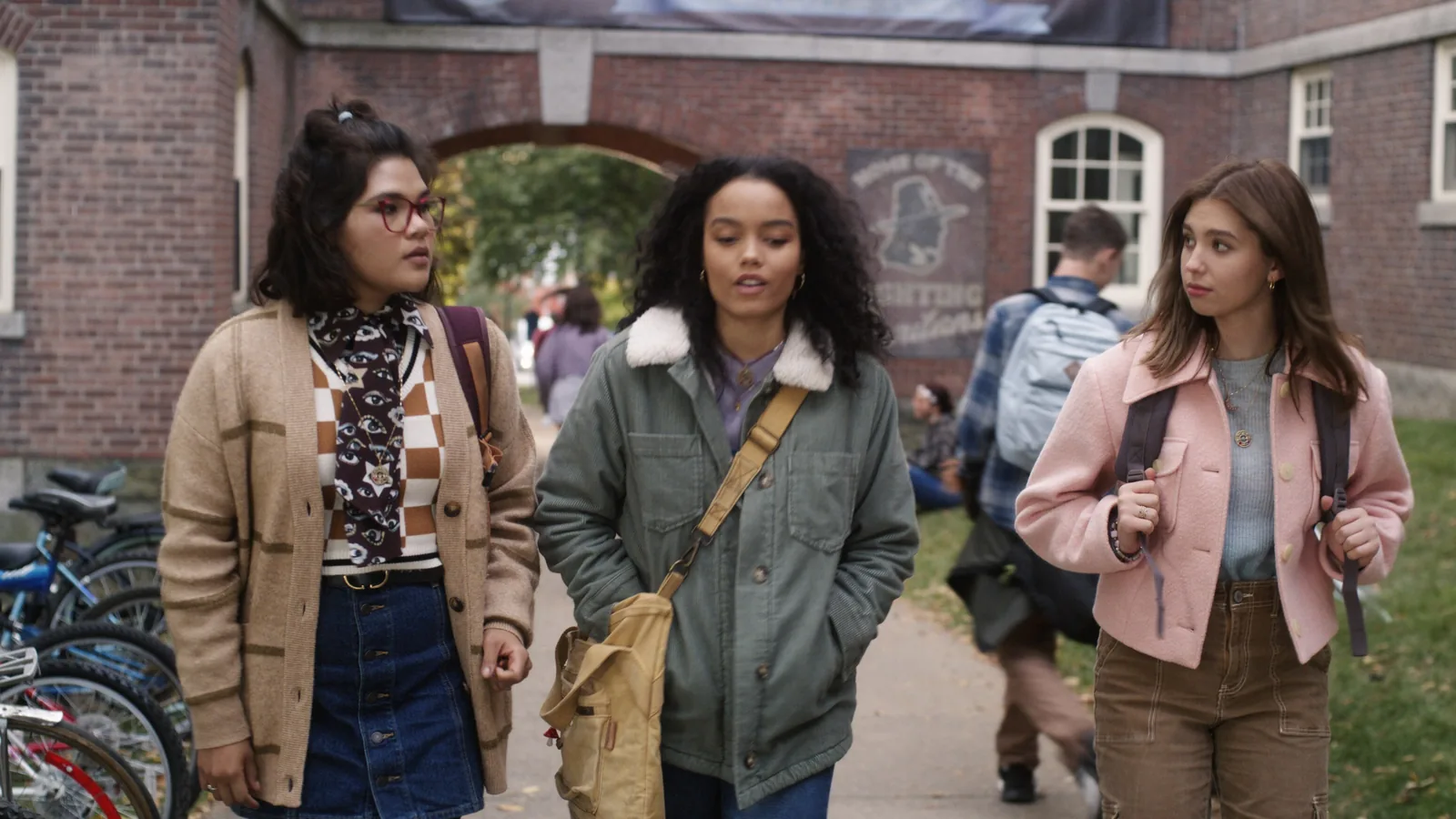 Izzy, Becca, and Cassie walk together outside a brick building in Hocus Pocus 2
