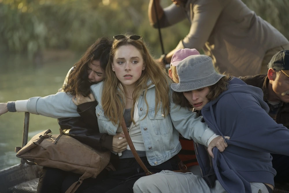 Sistine stretches her arms across fellow passengers on a boat in Hungry.