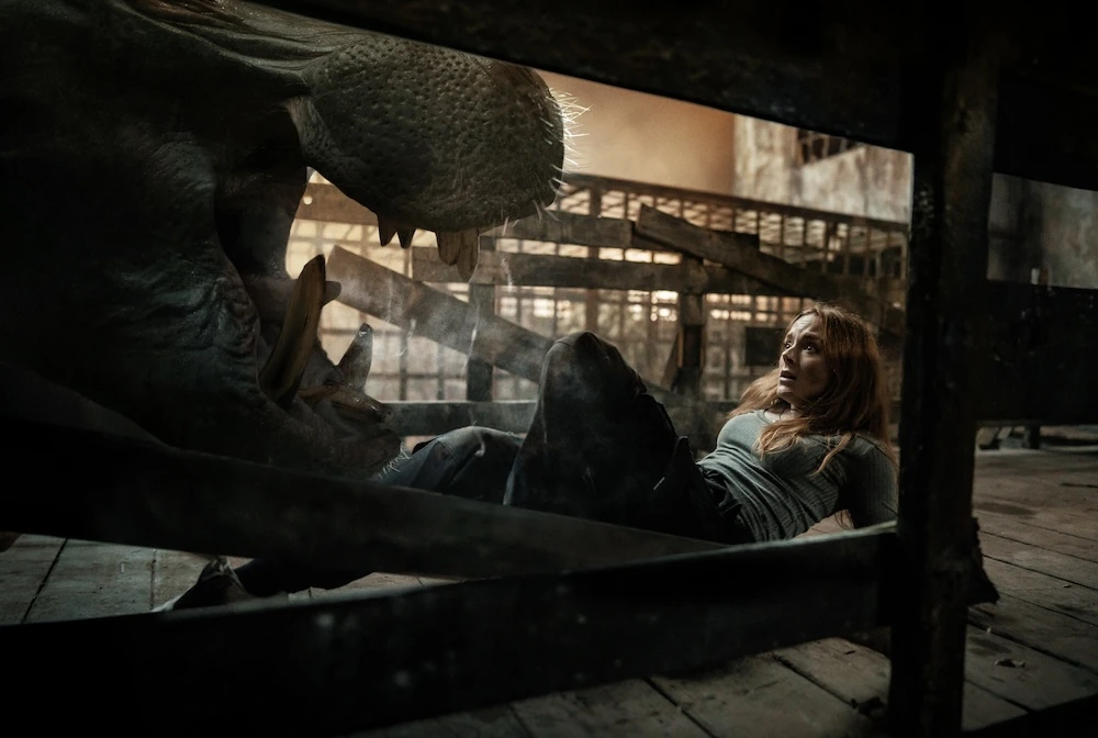 Sistine lies behind wooden rails as a hippopotamus opens its jaws in Hungry.