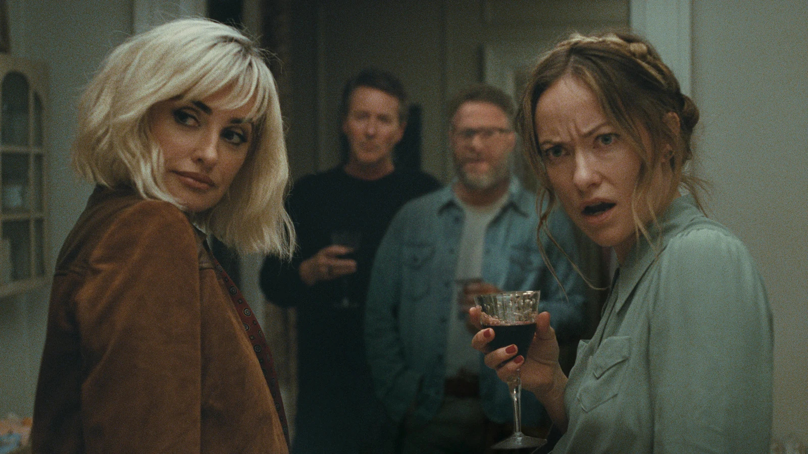 Pina and Angela look over their shoulders, with Hawk and Joe standing behind them in The Invite.
