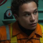 Chris Lemons wears an orange work suit and yellow harness in Last Breath.