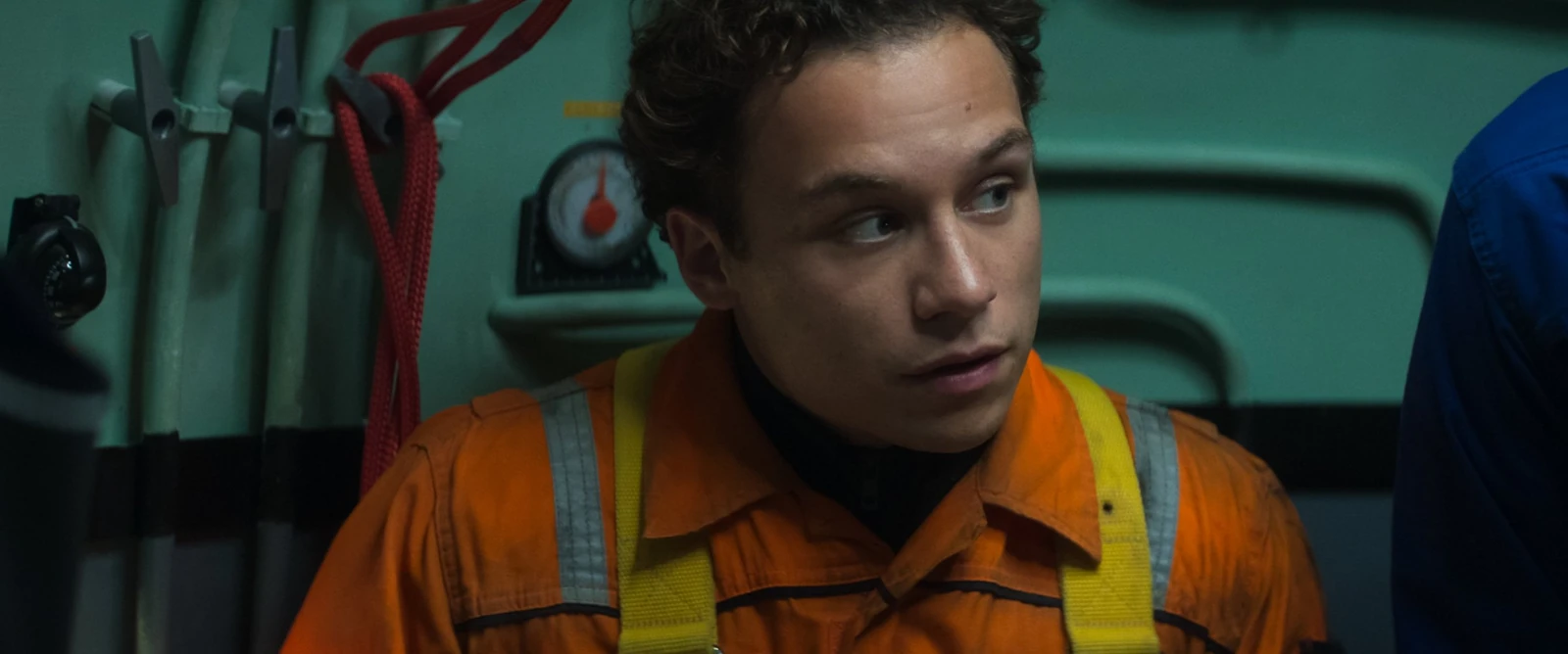 Chris Lemons wears an orange work suit and yellow harness in Last Breath.