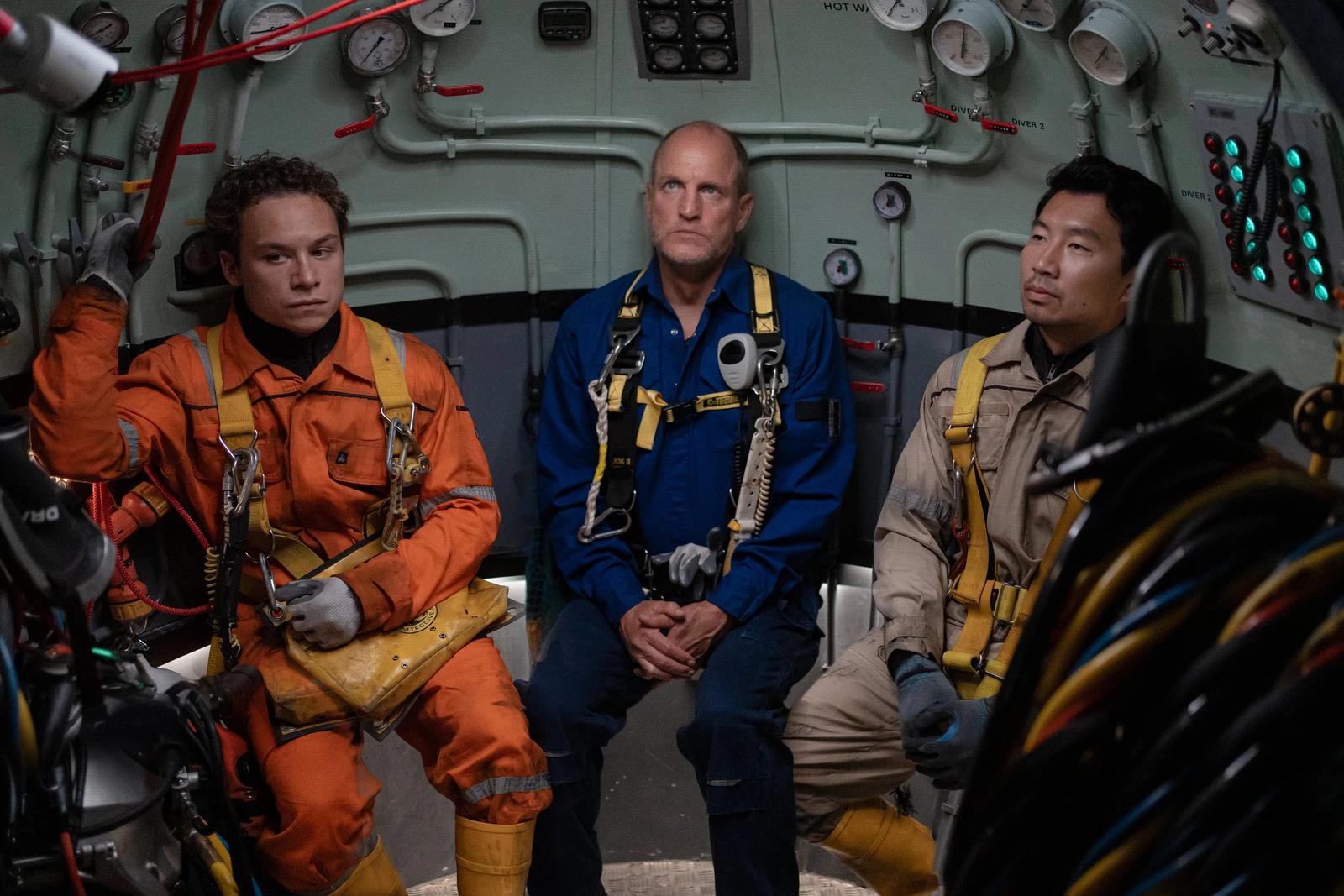 Chris, Duncan, and Dave sit side by side among pipes and gauges in Last Breath.