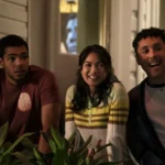 Anh stands between Jeremy and Malcolm on a balcony in The Love Hypothesis.