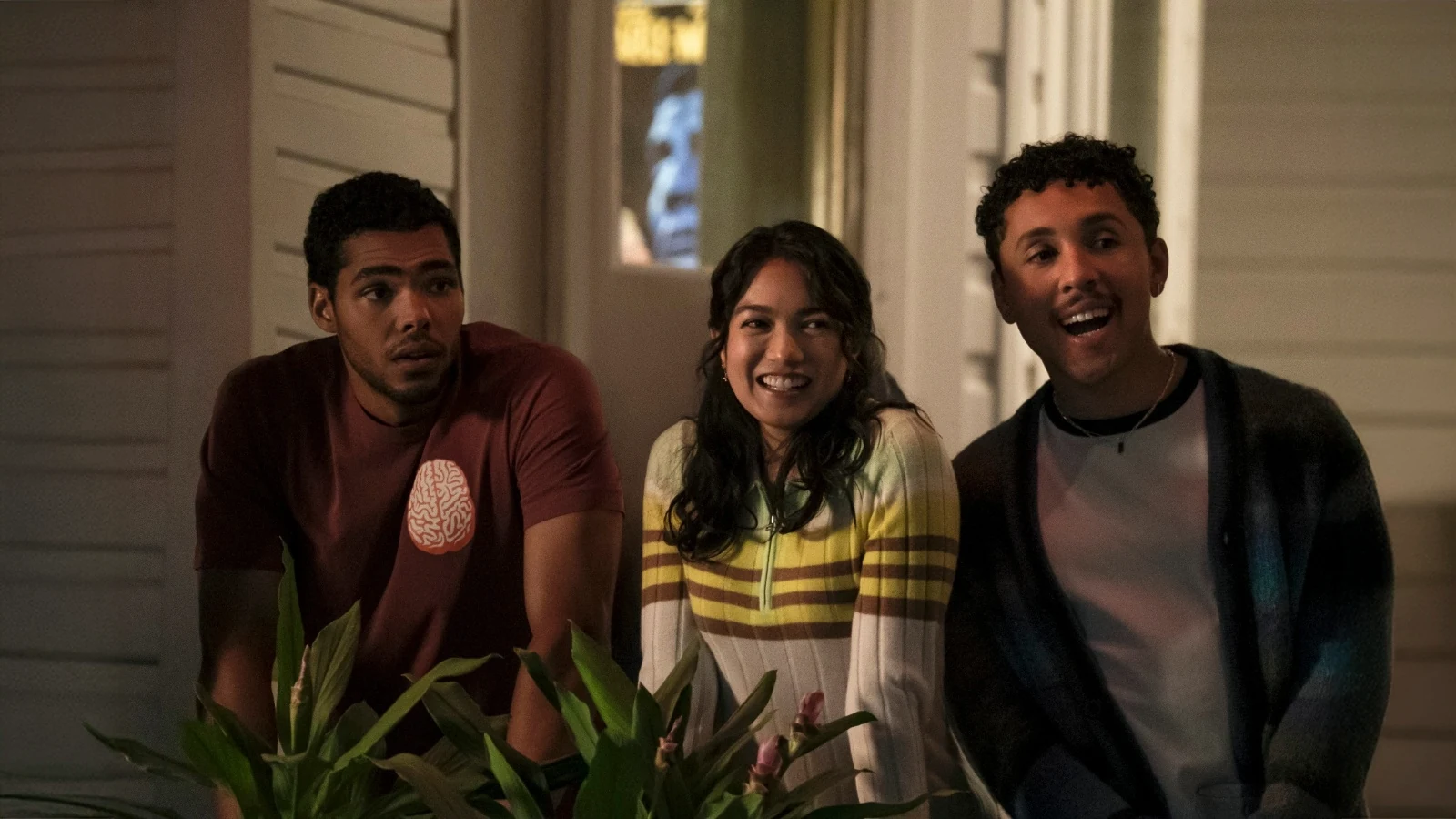 Anh stands between Jeremy and Malcolm on a balcony in The Love Hypothesis.