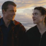 Maya and Charlie look at each other on a beach at sunset in Love of Your Life