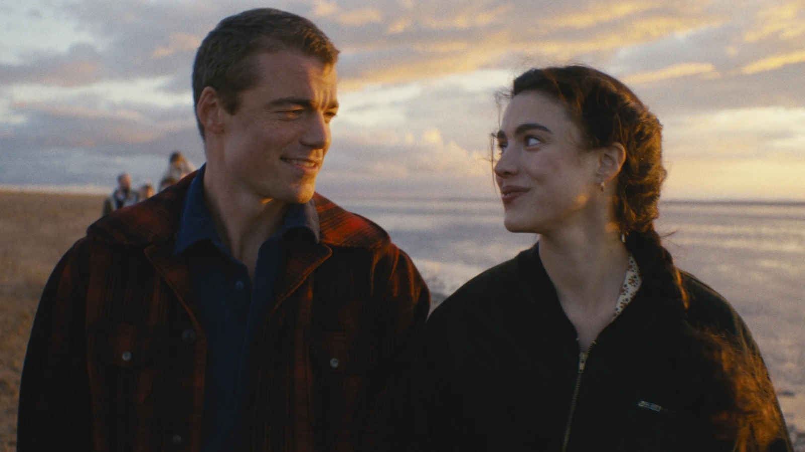 Maya and Charlie look at each other on a beach at sunset in Love of Your Life