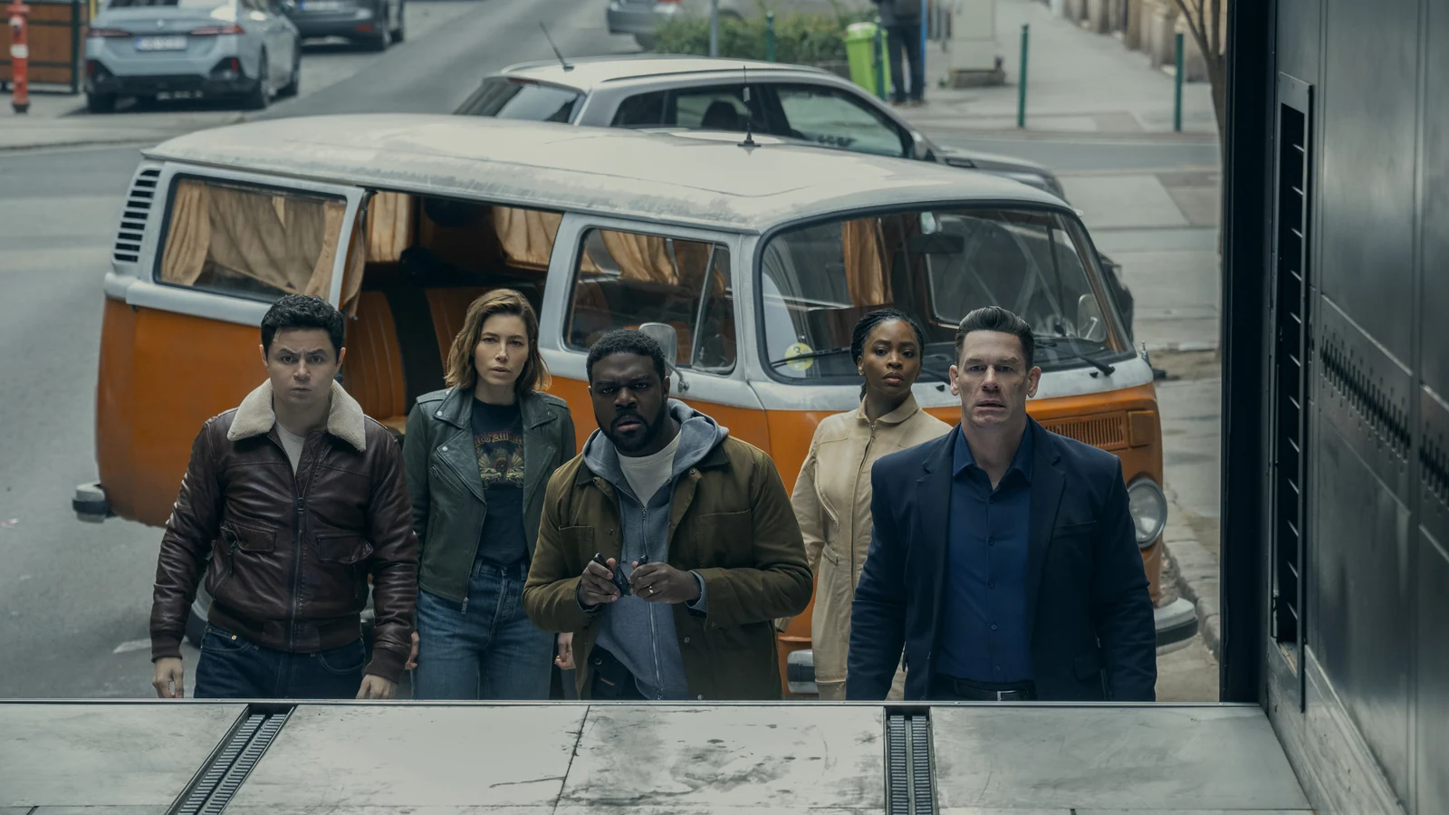 Ted, Aimee, Crosby, Charmaine, and Sean stand in front of an orange-and-white van in Matchbox The Movie.