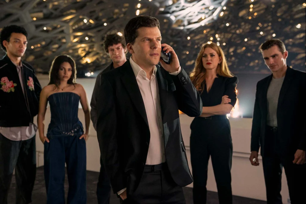 Atlas takes a phone call with Charlie and the other magicians gathered around him.