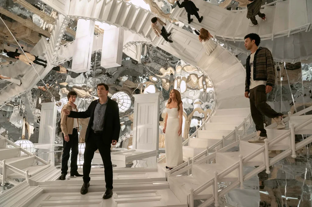 Charlie stands on a staircase beside Atlas, Bosco and Henley in a mirrored room.