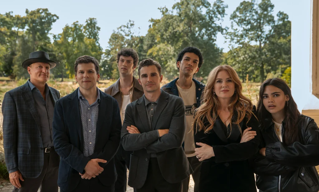 The four original Horsemen stand with Charlie, June and Bosco, with trees behind them.