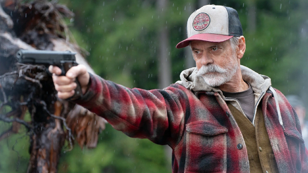 Stanley aims a handgun in the rain in One Mile.
