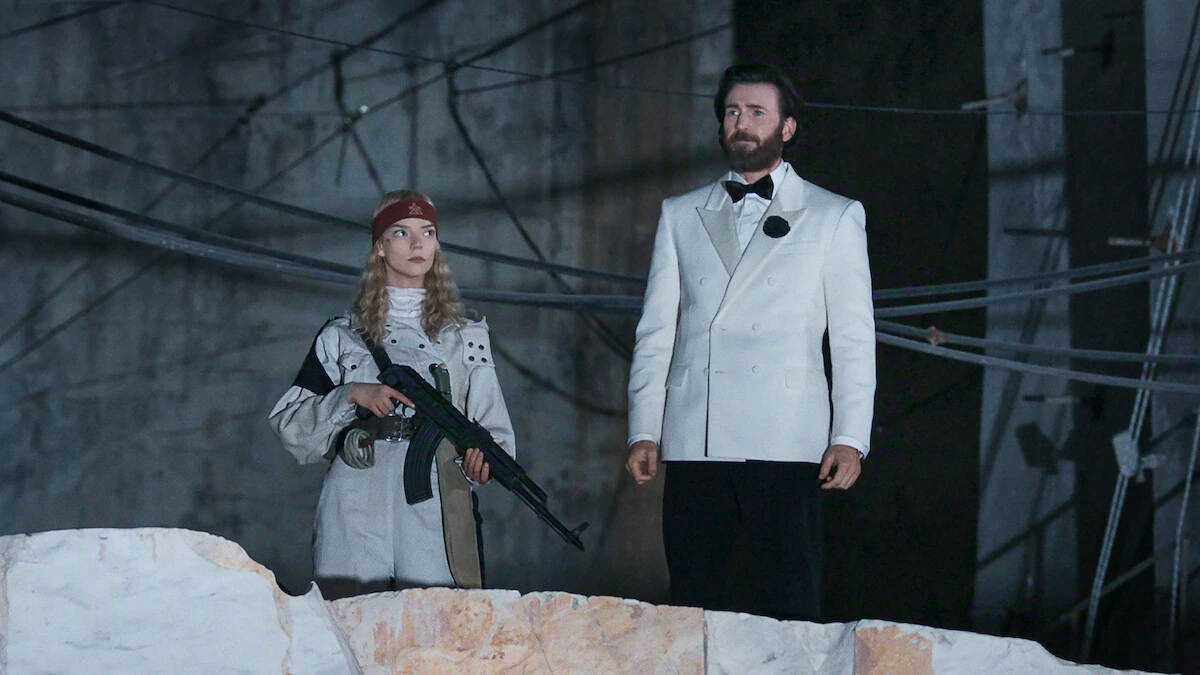 Joan holds a rifle beside Mike Tyler in a white dinner jacket in Sacrifice