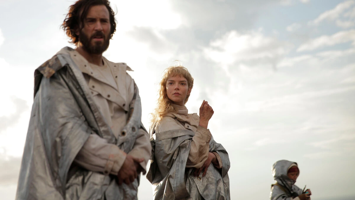 Mike and Joan wear silver cloaks outdoors, with a hooded figure behind them in Sacrifice
