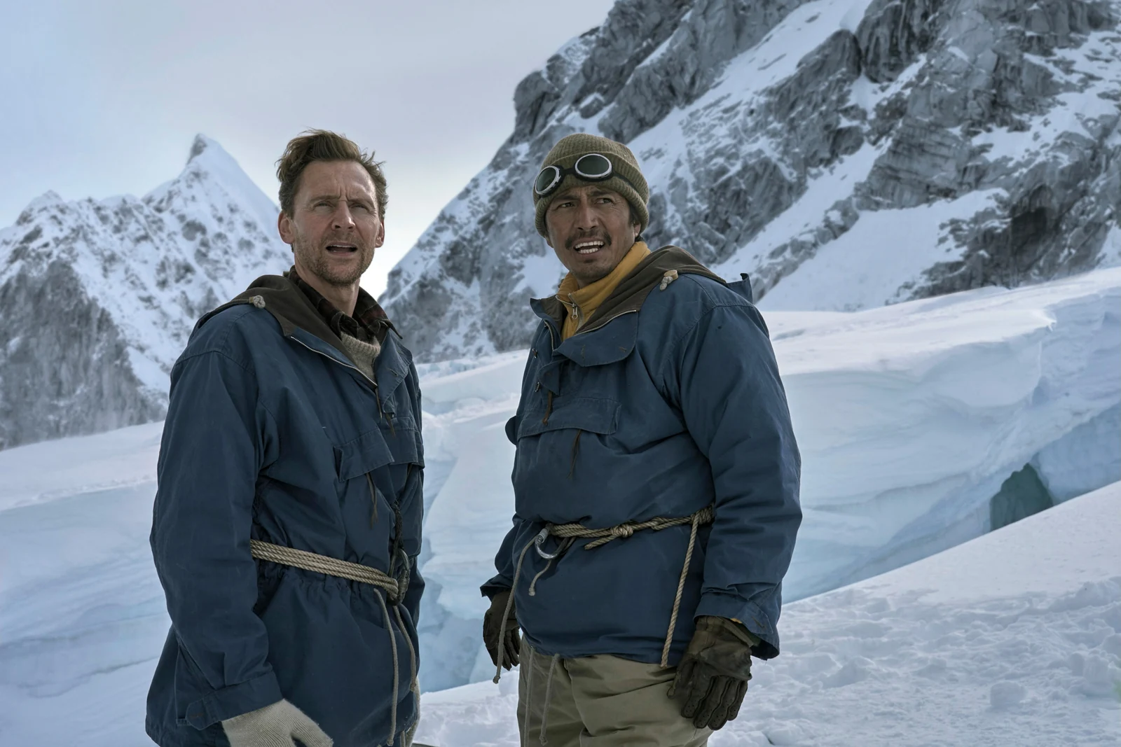Edmund Hillary and Tenzing Norgay standing together on a snowy mountainside