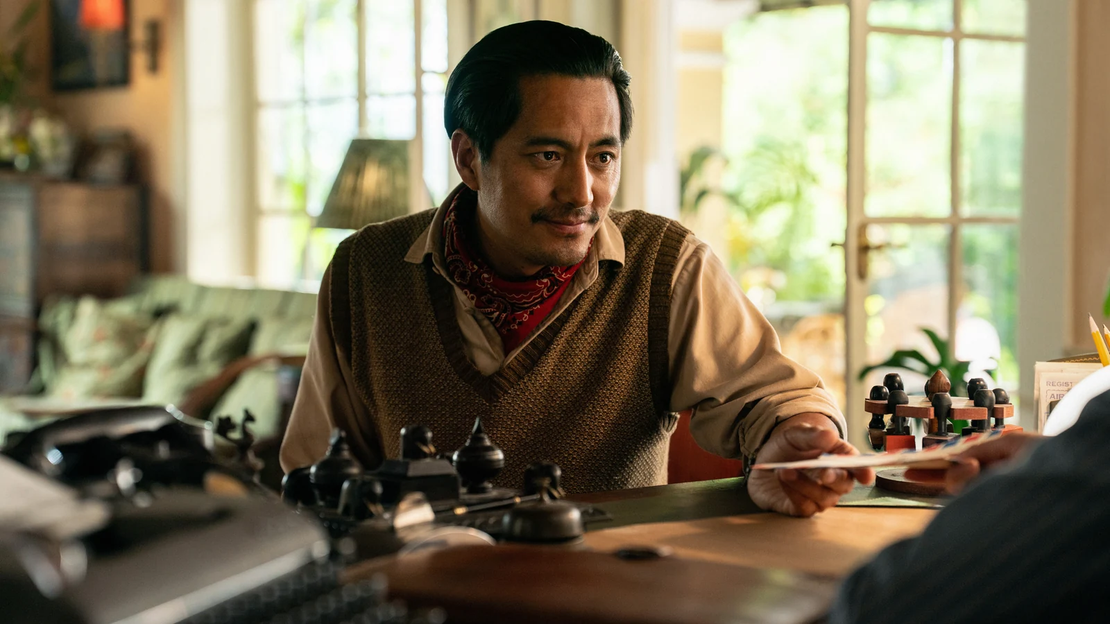 Tenzing Norgay holding a paper across a desk