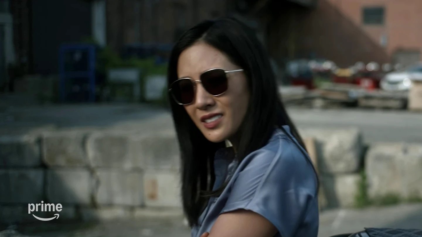 Katie Buranek wears sunglasses and a blue shirt outdoors in The Terminal List Season 2.
