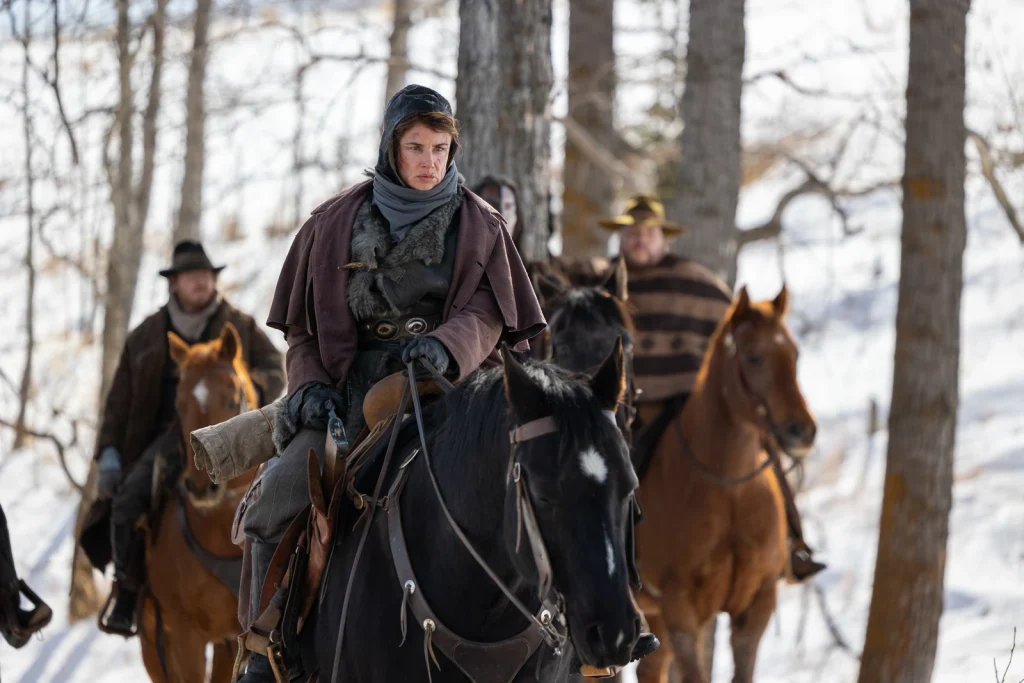 Cut Throat Bill rides a black horse through a snowy forest in The Thicket