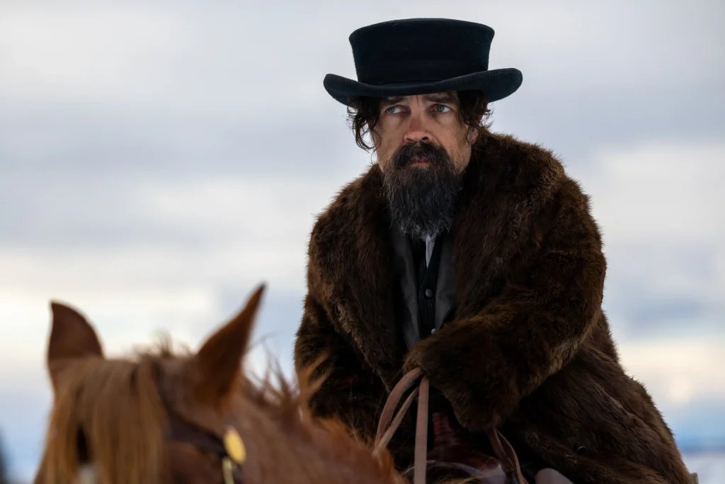 Reginald Jones wears a black top hat and a fur coat on horseback in The Thicket